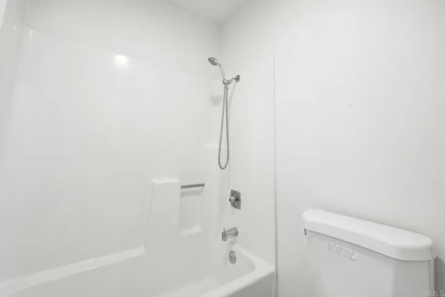 a bathroom with a shower and a toilet