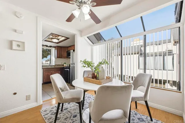 a dining room with furniture a window and wooden floor