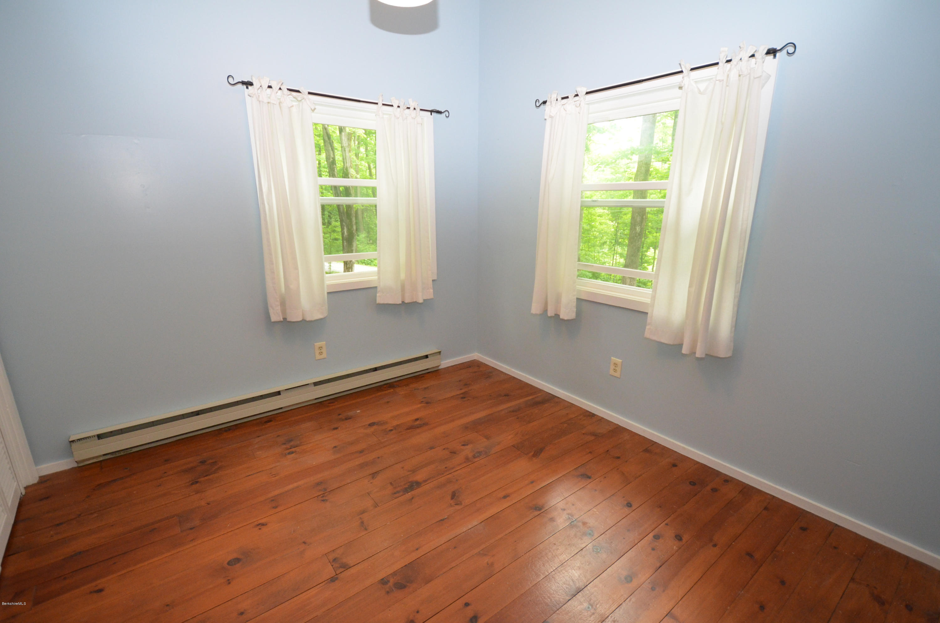 204 Stebbins Road Otis, MA 01253 - Photo 8 of 9 a view of an empty room with wooden floor and a window