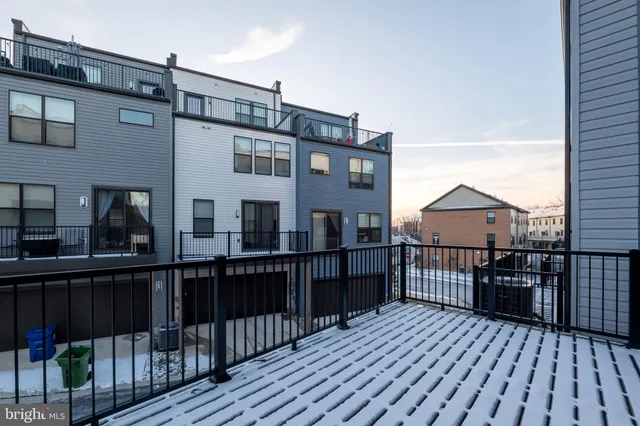 a view of a house with wooden deck front of house