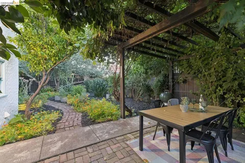a view of a patio with table and chairs and potted plants