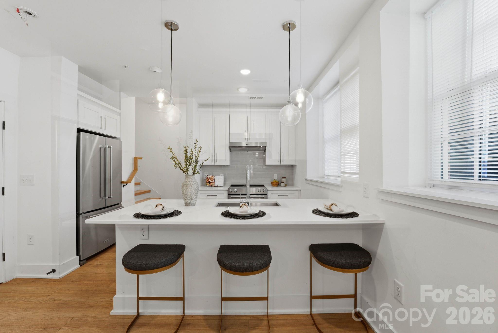 201 Grandin Road, Unit 6 Charlotte, NC 28208 - Photo 7 of 45 a kitchen with stainless steel appliances kitchen island granite countertop a sink and a refrigerator
