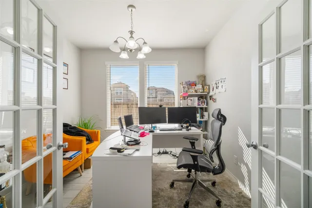 a view of a workspace with furniture and a window