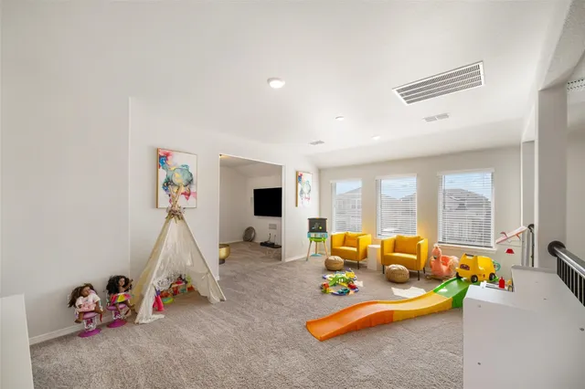 a living room with furniture gym equipment and a large window