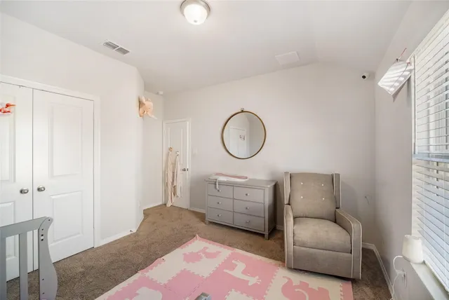 a living room with furniture a mirror and a window