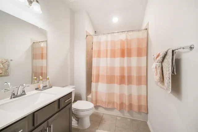 a bathroom with a double vanity sink toilet and shower
