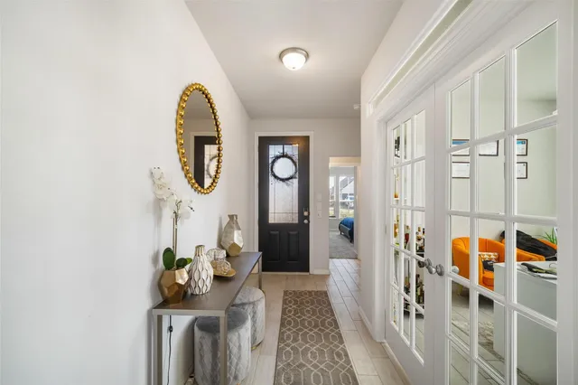 a view of a hallway with entryway wooden floor and front door