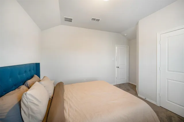 a bedroom with a bed and pillows