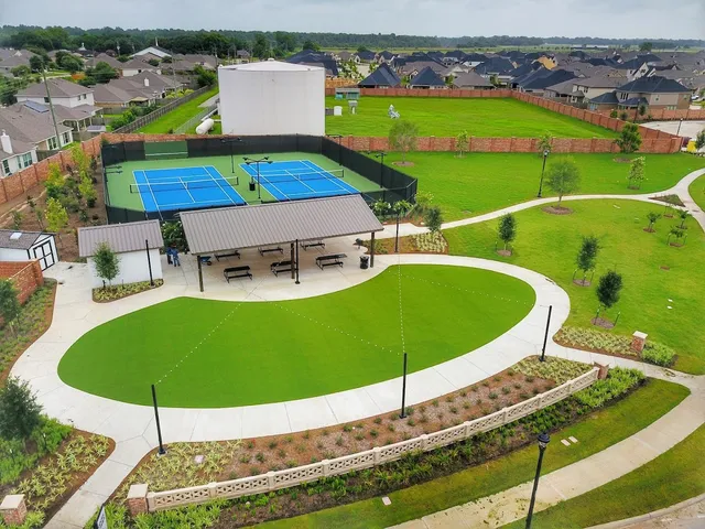 a view of a swimming pool with lawn chairs under an umbrella