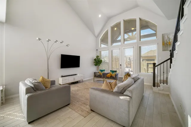 a living room with furniture wooden floor and a flat screen tv