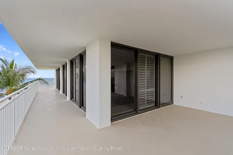 a view of a hallway with wooden floor and entryway