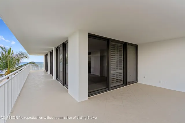 a view of a hallway with wooden floor and entryway