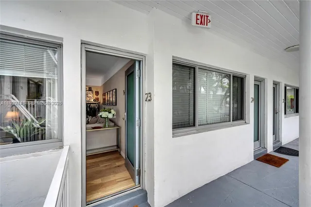 a view of a livingroom with wooden floor and furniture