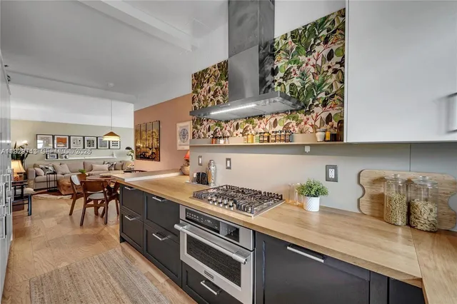 a kitchen with stainless steel appliances granite countertop a stove a sink and a refrigerator