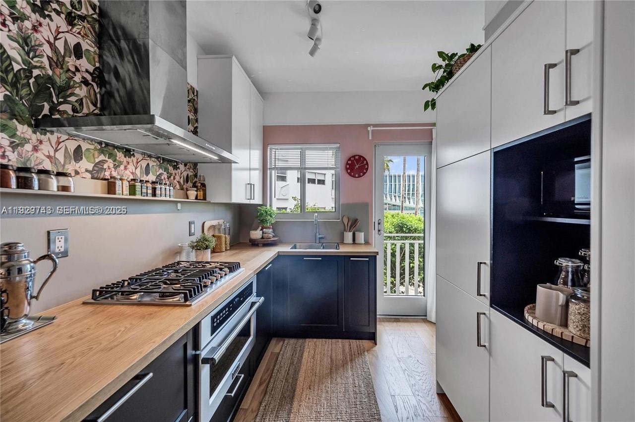 1840 James Avenue, Unit 23 Miami Beach, FL 33139 - Photo 7 of 10 a kitchen with stainless steel appliances granite countertop a stove and a refrigerator