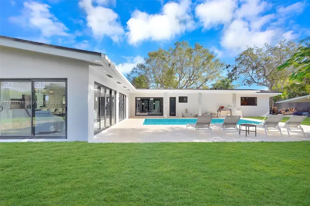 a patio with garden area and outdoor seating