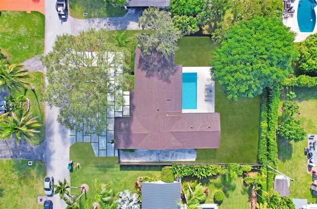 an aerial view of a house with a yard and a fountain