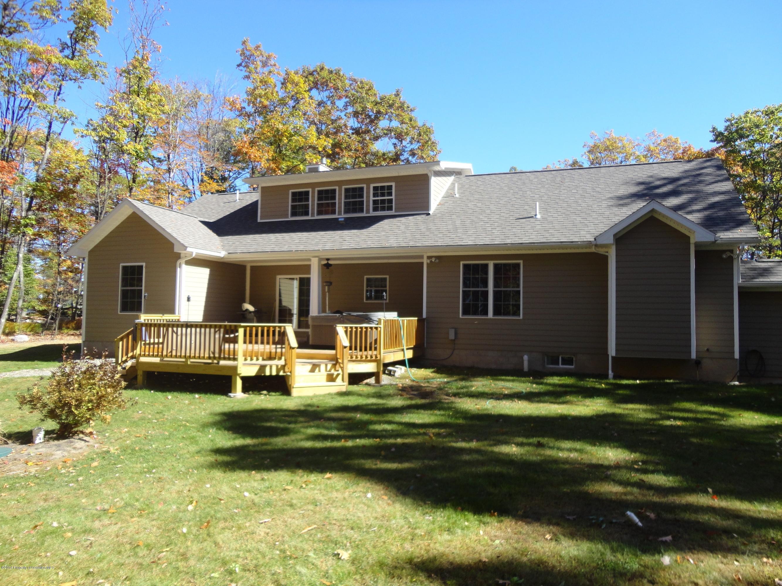 910 Line Road Lake Ariel, PA 18436 - Photo 9 of 48 a front view of a house with a garden and patio