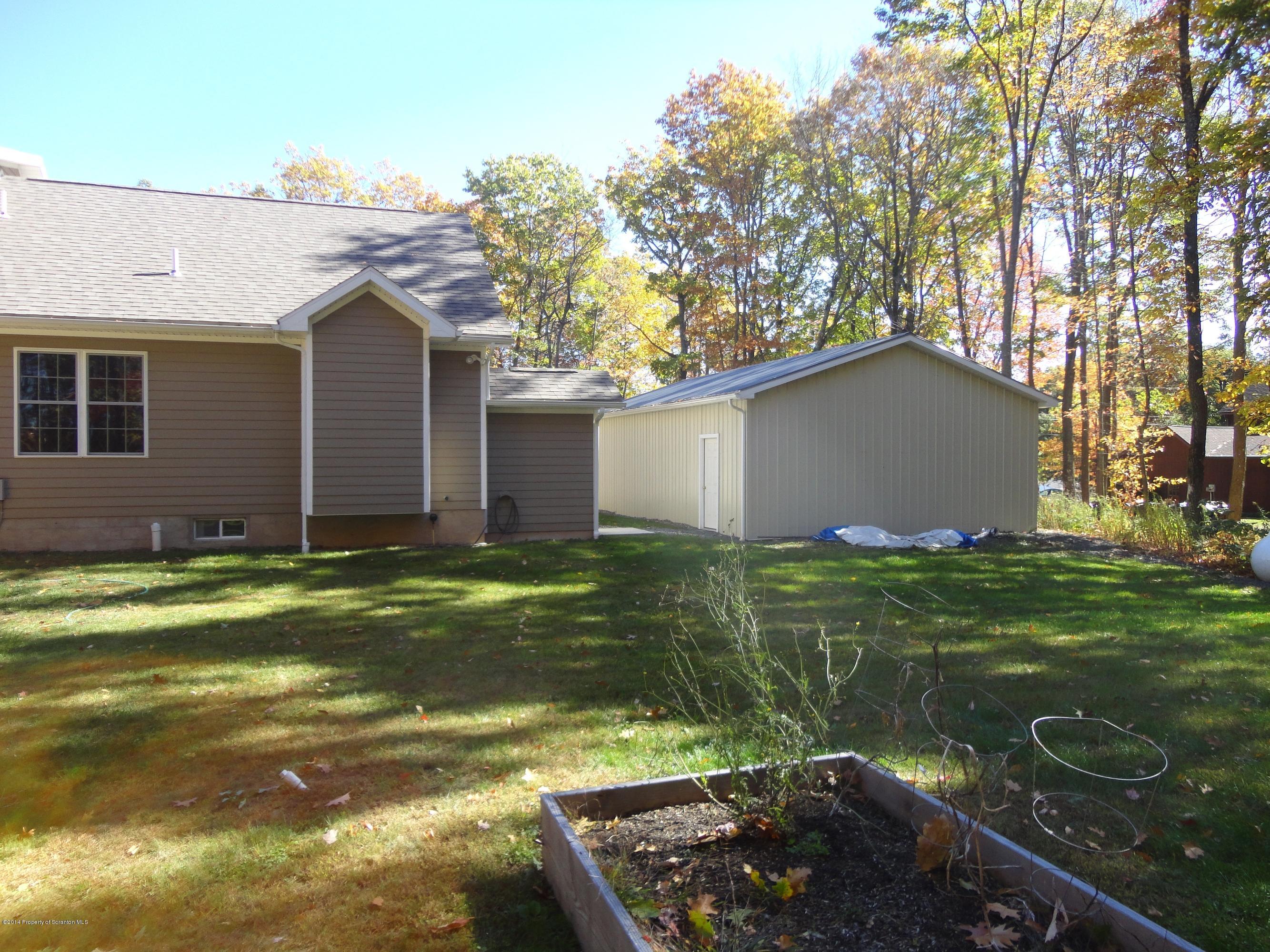 910 Line Road Lake Ariel, PA 18436 - Photo 10 of 48 a backyard of a house with lots of green space and plants
