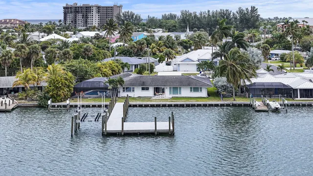 a aerial view of a house with a garden and lake view