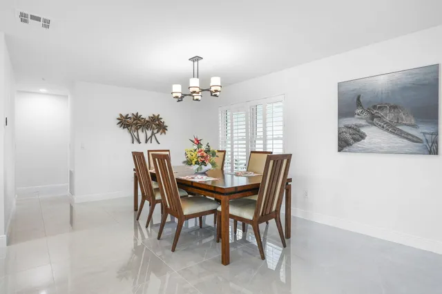 a bathroom with a granite countertop sink a mirror and shower