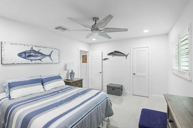 a view of a swimming pool with a lounge chairs in front of house