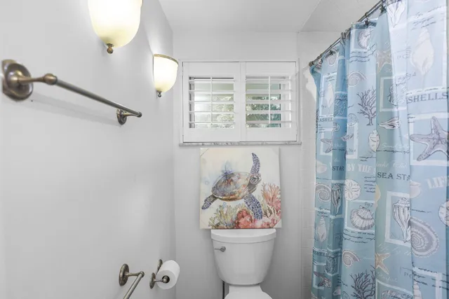 a view of a lake with boats and trees in the background