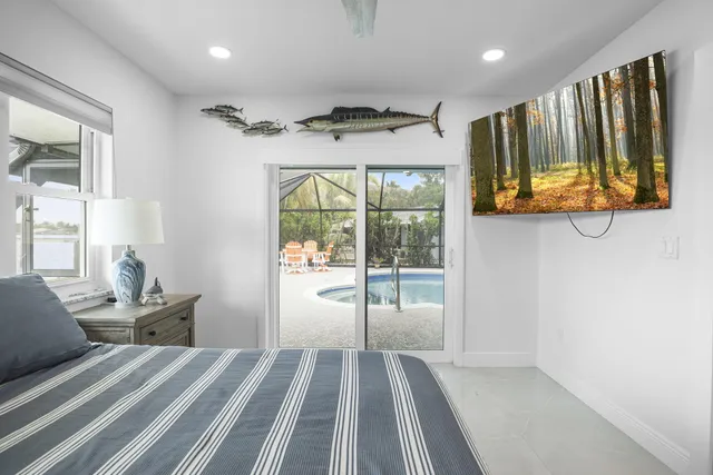 a view of a house with backyard and swimming pool