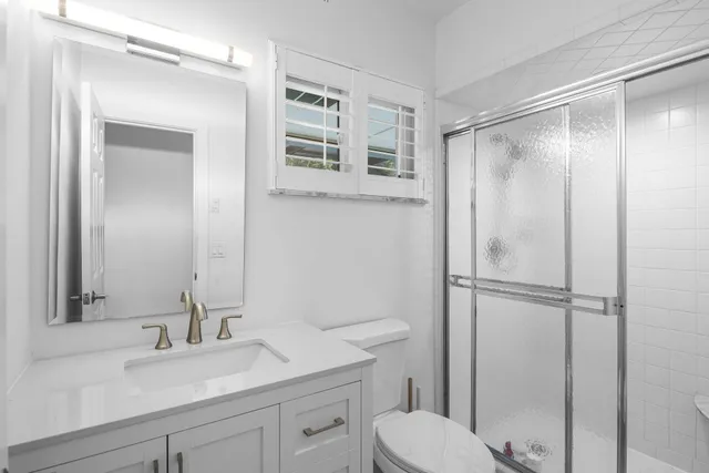 a view of a house with a yard and potted plants