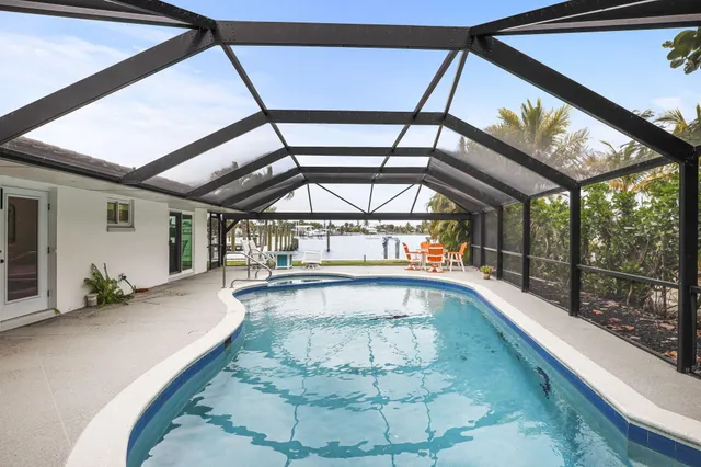 front view of a house with a yard and potted plants