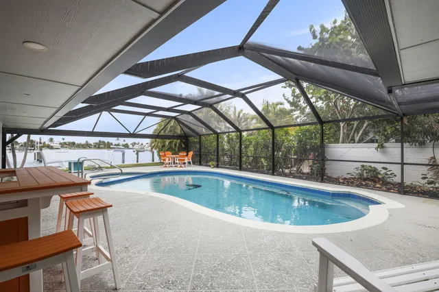 a view of a house with backyard and a tree