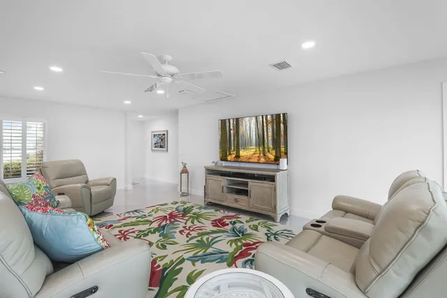 a kitchen with a dining table chairs and view of living room