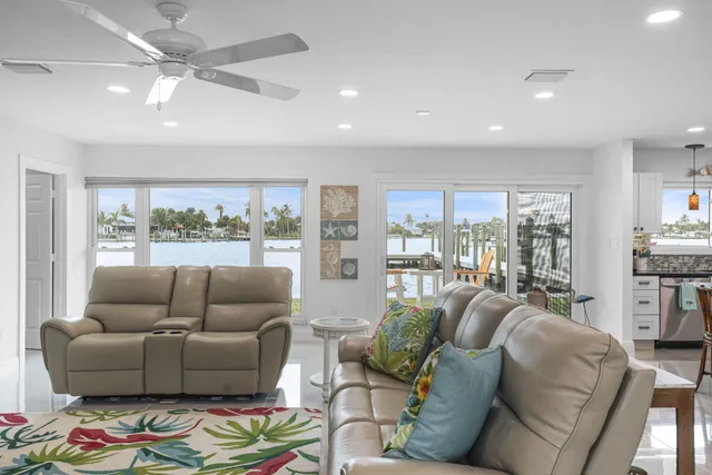 a kitchen with stainless steel appliances kitchen island granite countertop a refrigerator and a sink