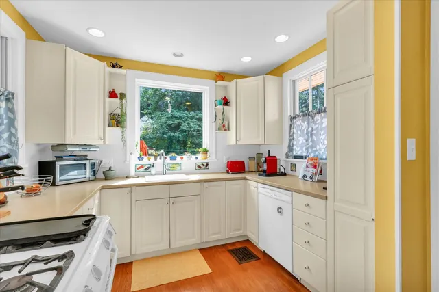 a kitchen with a sink cabinets and window