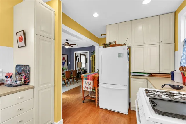a kitchen with stainless steel appliances granite countertop a refrigerator and a stove top oven