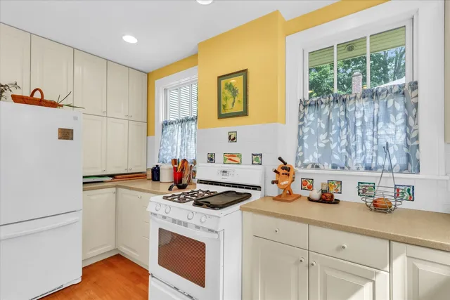 a kitchen with stainless steel appliances a stove a refrigerator and a cabinets