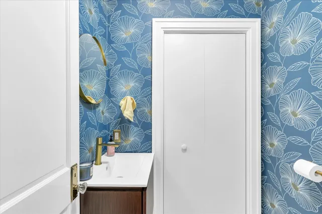 a bathroom with a sink and mirror with toilet