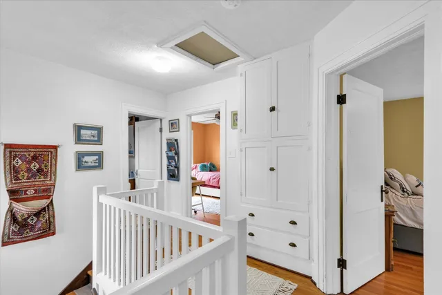 a view of a hallway with bedroom and wooden floor