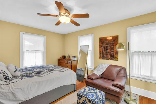 a bedroom with a bed couch and window