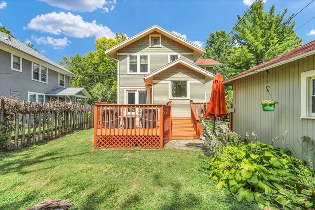 a backyard of a house with table and chairs