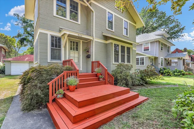 a wooden bench sitting in front of a house