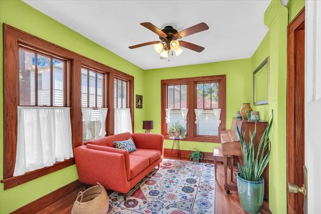 a living room with furniture a floor to ceiling window and a flat screen tv