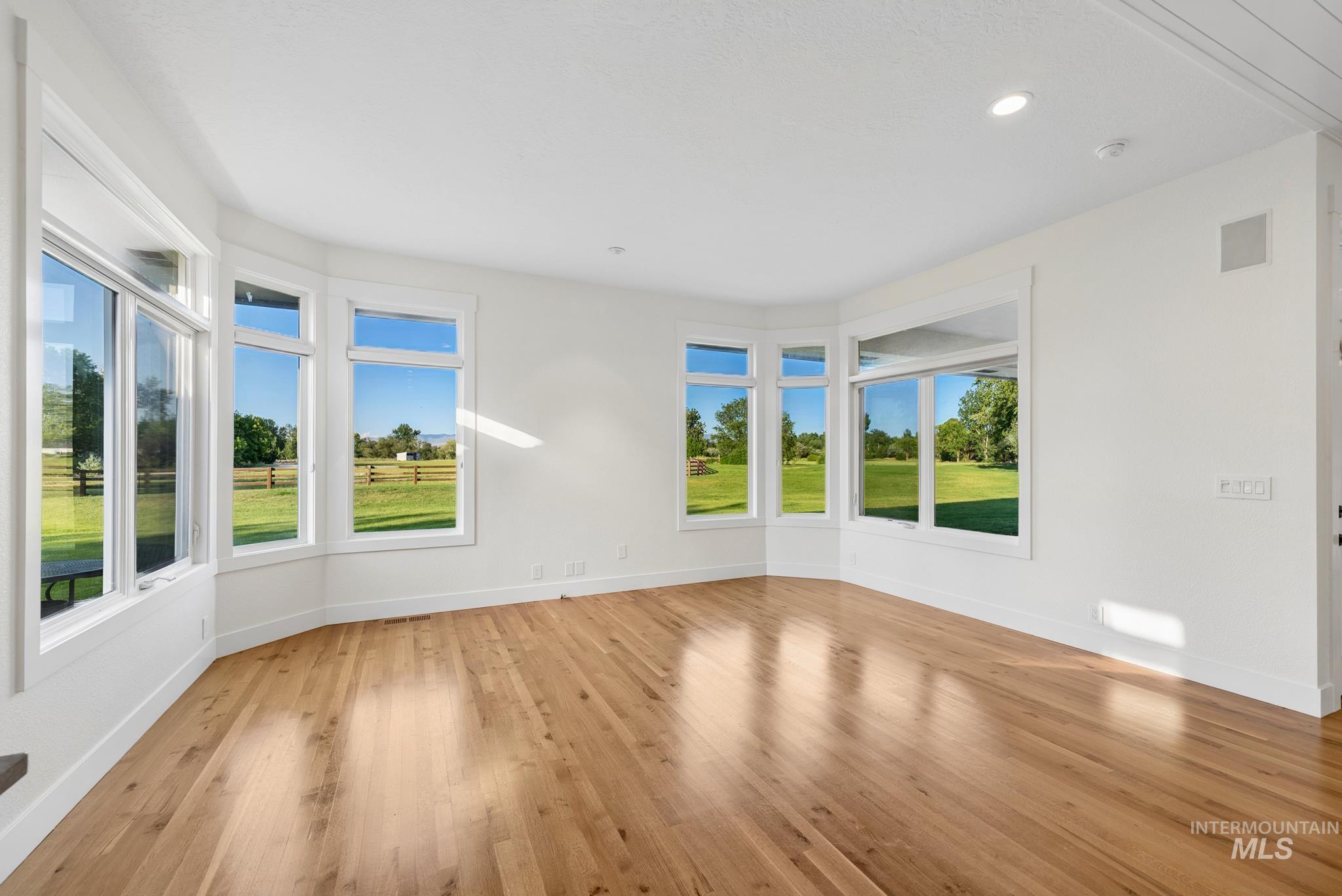 2050 Artesian Road Eagle, ID 83616 - Photo 15 of 49 Hardwood flooring throughout this spacious room, featuring a built-in cabinetry unit with a stone countertop and subway tile backsplash
