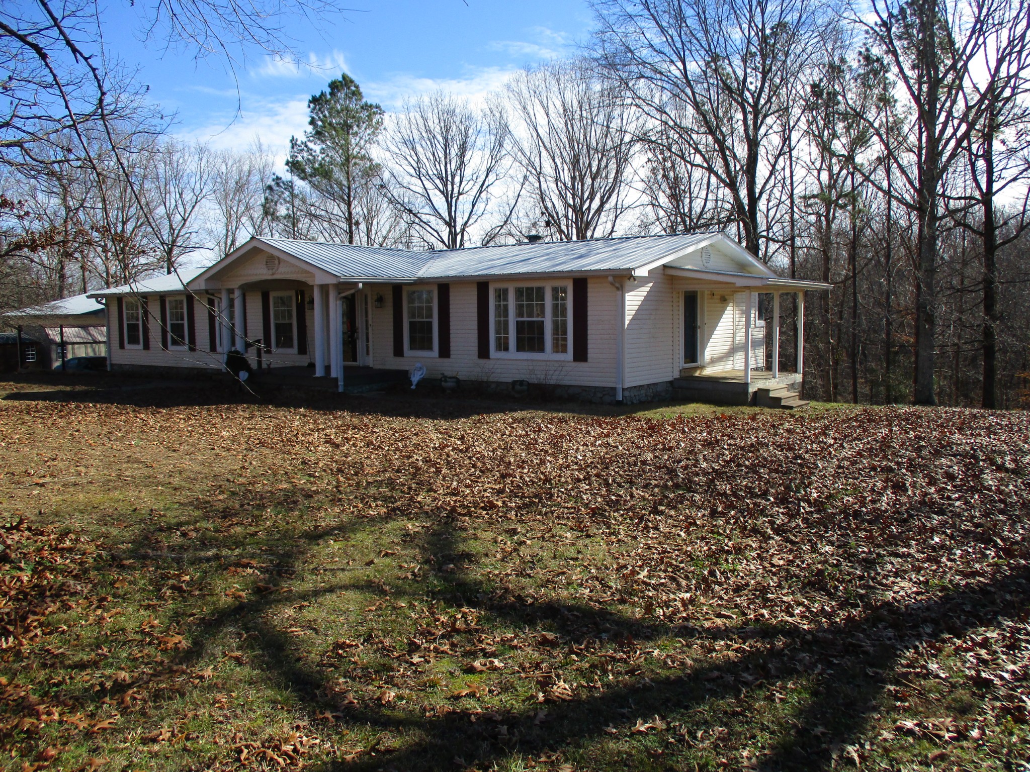 908 Bear Cub Run Centerville, TN 37033 - Photo 13 of 17 a front view of a house with a garden