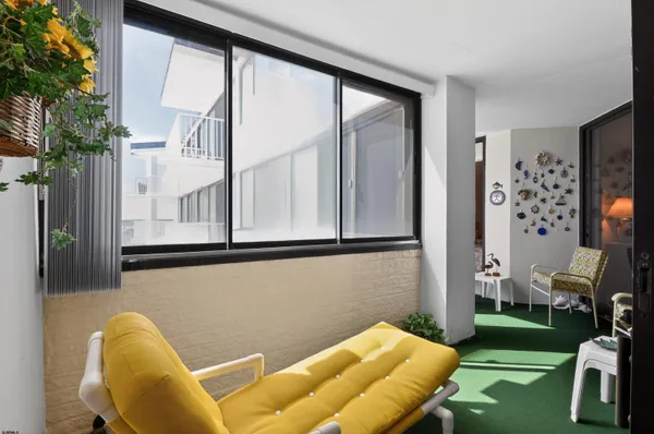 a living room with furniture and a wall painting
