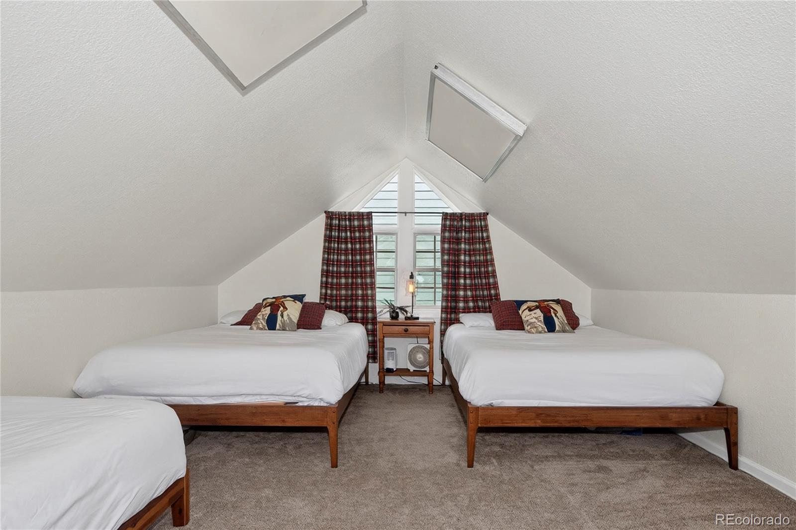 327 Vasquez Road, Unit E1 Winter Park, CO 80482 - Photo 37 of 43 a bedroom with bed and a chandelier fan