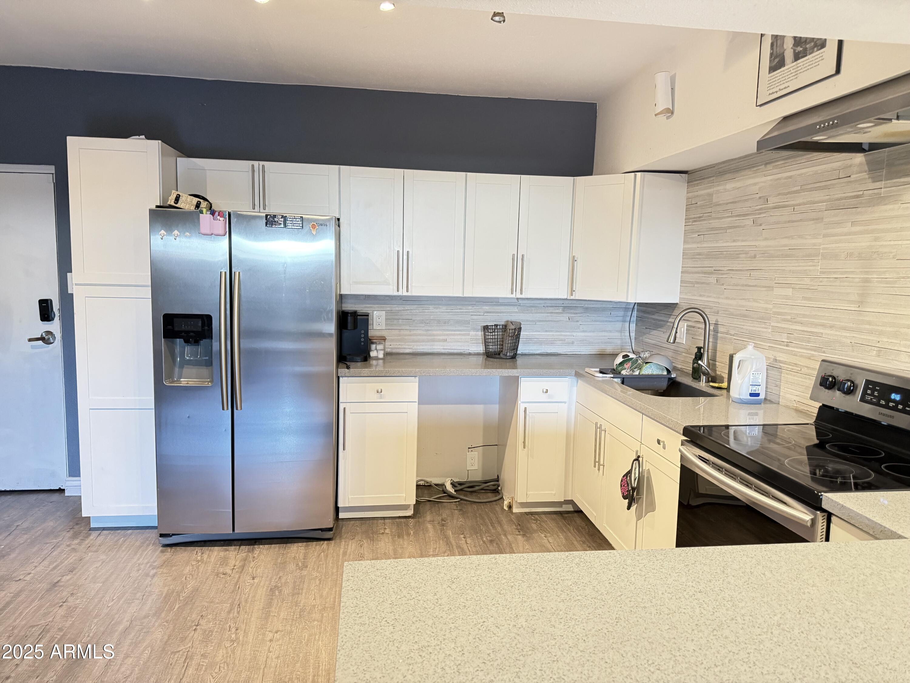 357 East Thomas Road, Unit A105 Phoenix, AZ 85012 - Photo 11 of 51 a kitchen with a refrigerator sink and stove