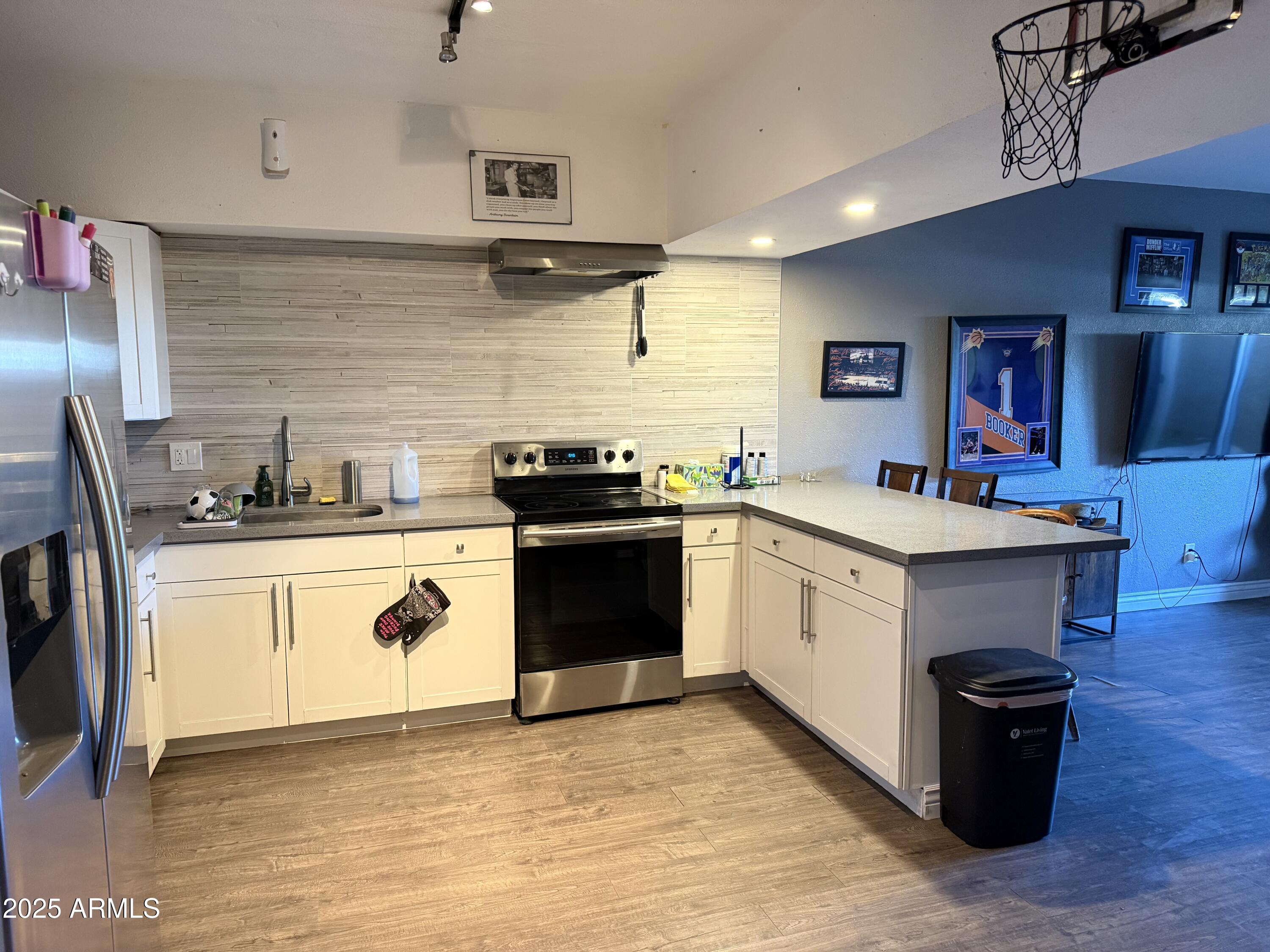 357 East Thomas Road, Unit A105 Phoenix, AZ 85012 - Photo 13 of 51 a kitchen with a sink stove and cabinets