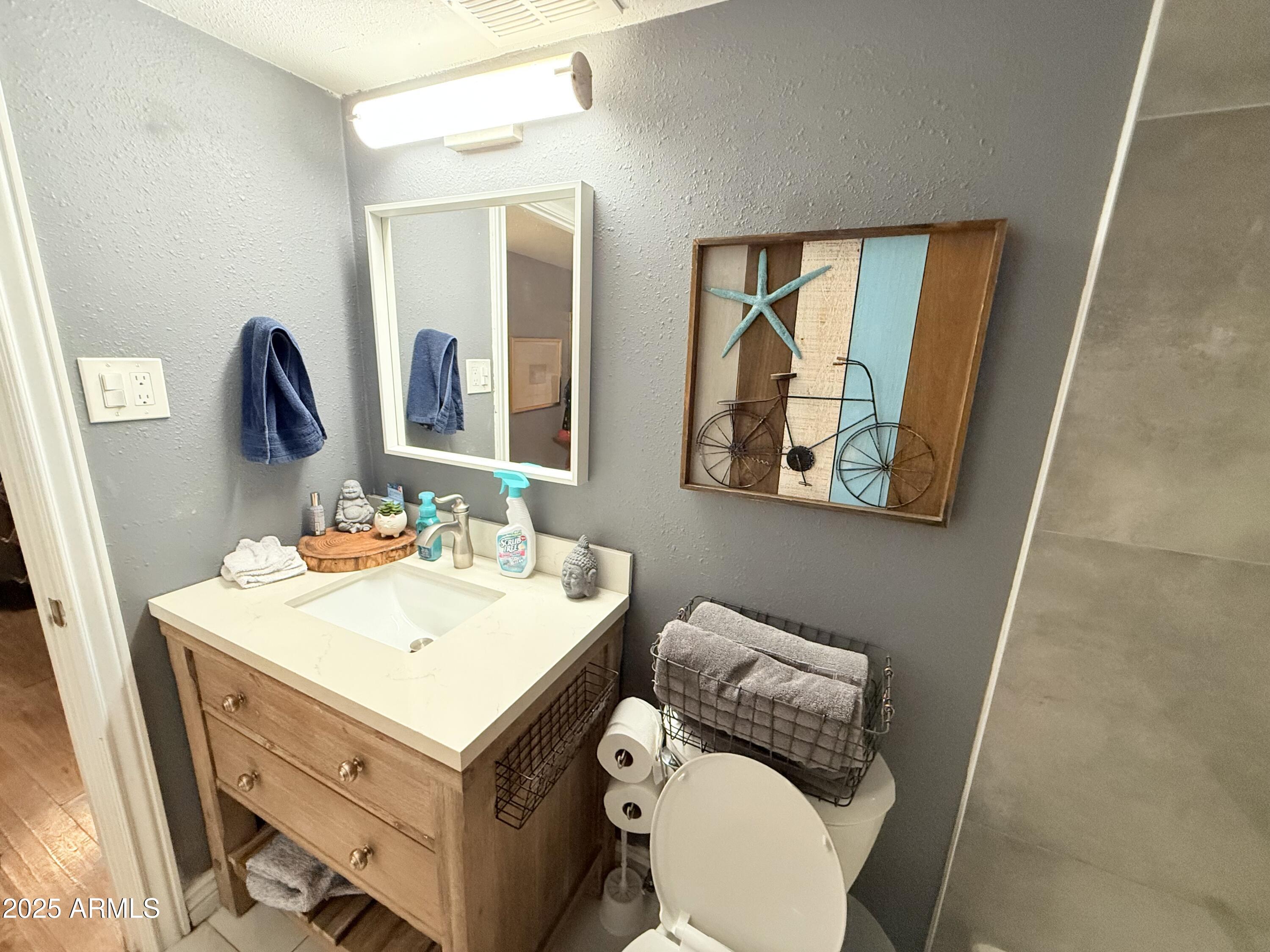 357 East Thomas Road, Unit A105 Phoenix, AZ 85012 - Photo 19 of 51 a bathroom with a toilet sink and mirror