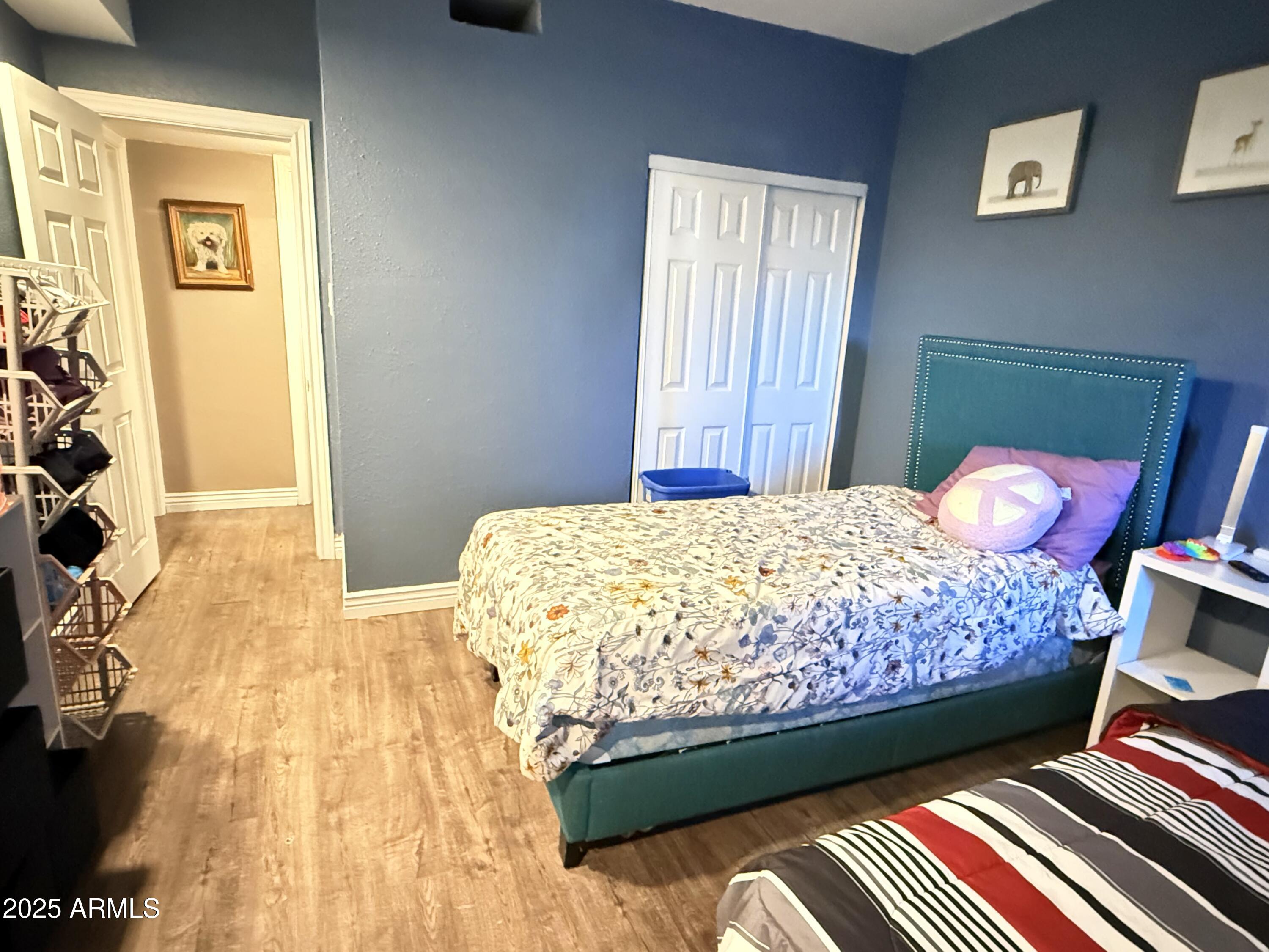 357 East Thomas Road, Unit A105 Phoenix, AZ 85012 - Photo 23 of 51 a bedroom with a bed and wooden floor